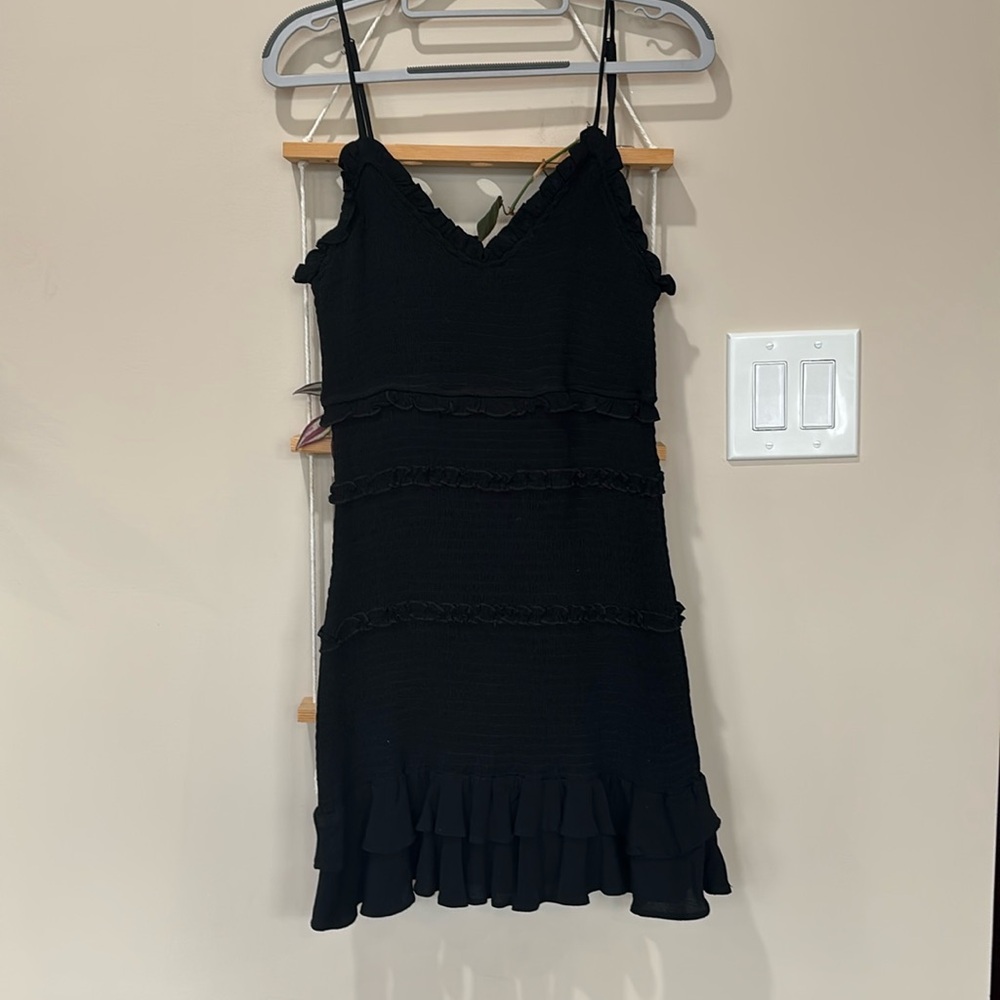 Form fittingg with ruffles, a little black dresss for any activity